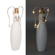 White resin angel with led and heart cm10x5h24
