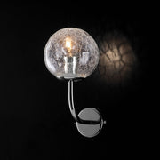Modern wall lamp in polished chrome iron with transparent glass sphere
